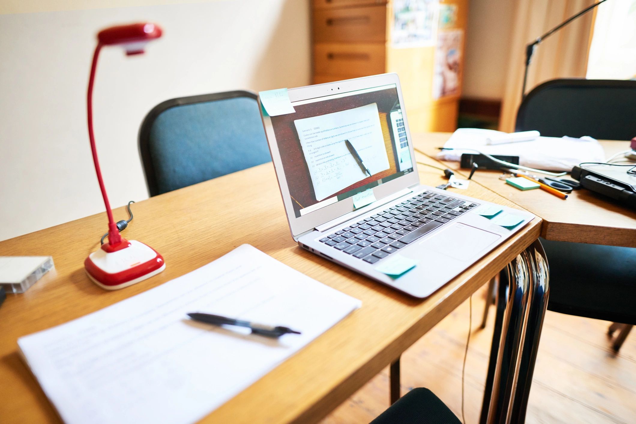 Study desk with laptop and notes for exam preparation