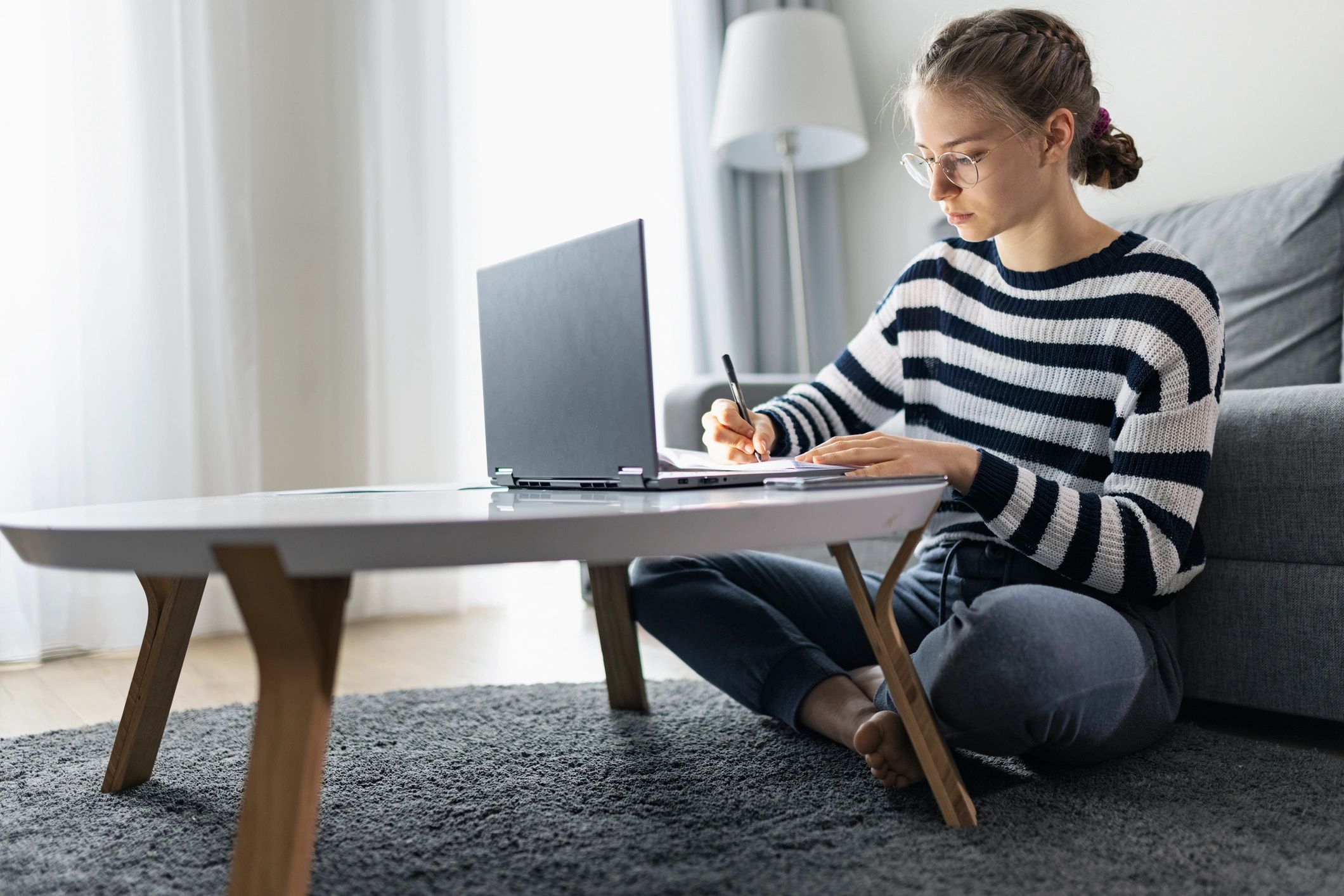 Student attending an online tutoring session on a laptop.