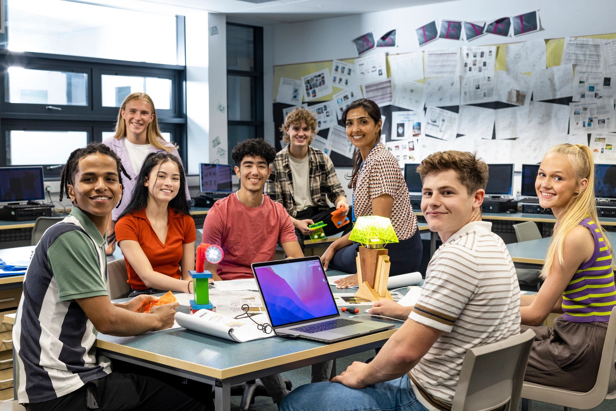 Students collaborating with a teacher in a classroom setting