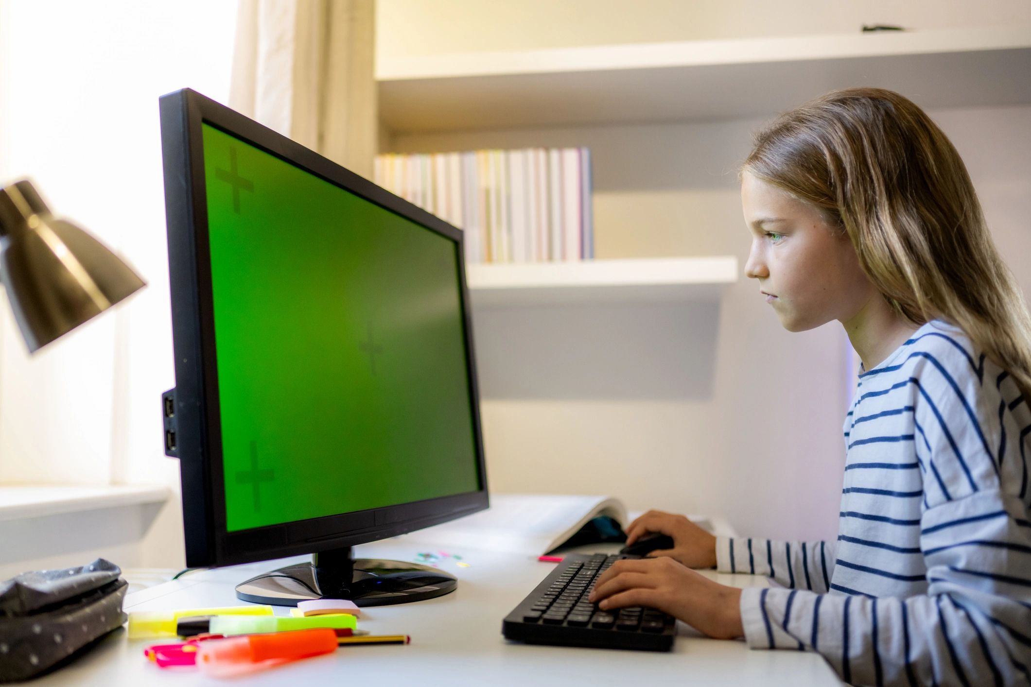 Girl using computer and typing on keyboard